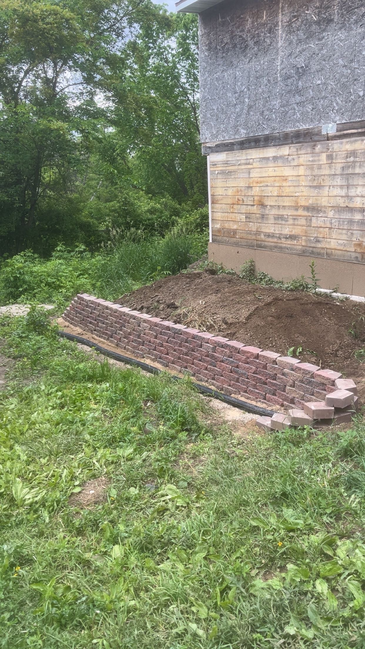 Finished tiered block retaining wall in an Iowa backyard