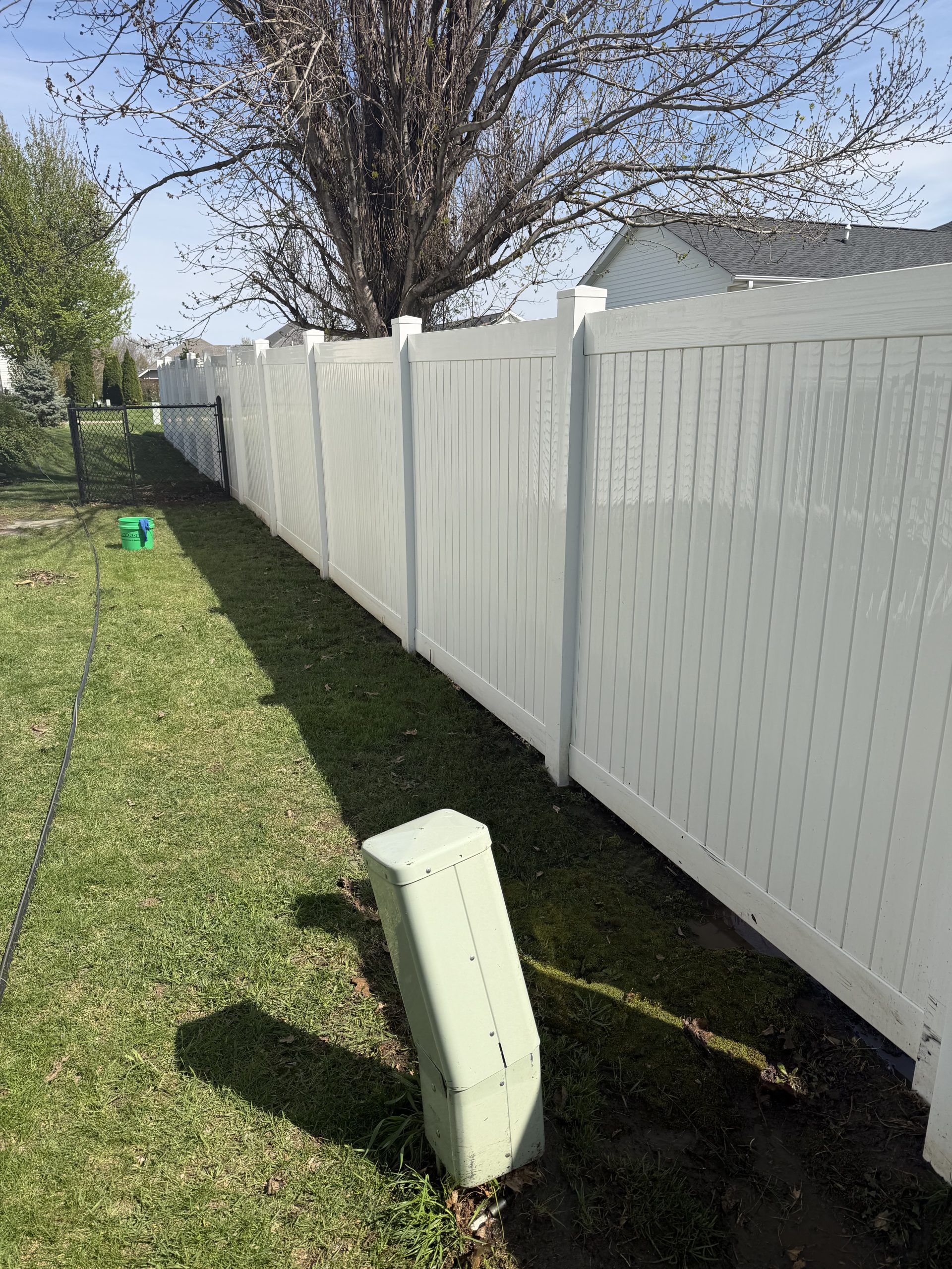 Wooden fence after power washing by OddJobs, clean and restored